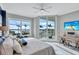 Comfortable bedroom with floor to ceiling windows, allowing for natural light and water views with outdoor balcony access at 130 Riviera Dunes Way # 203, Palmetto, FL 34221