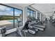 Well-equipped gym with treadmills and exercise bikes overlooking the outdoor pool area at 130 Riviera Dunes Way # 203, Palmetto, FL 34221