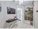 Hallway featuring neutral walls, tiled floors, and an accent table with stylish décor at 130 Riviera Dunes Way # 203, Palmetto, FL 34221