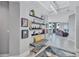 Hallway with stylish décor, decorative shelving, bench, and views into the living area at 130 Riviera Dunes Way # 203, Palmetto, FL 34221