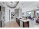 Modern kitchen with stainless steel appliances, stylish lighting and open access to the living and dining area at 130 Riviera Dunes Way # 203, Palmetto, FL 34221