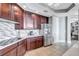 Well-lit kitchen with dark wood cabinets, quartz countertops, and stainless steel appliances at 130 Riviera Dunes Way # 203, Palmetto, FL 34221