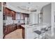 Modern kitchen with stainless steel appliances, dark wood cabinetry, and island with breakfast bar at 130 Riviera Dunes Way # 203, Palmetto, FL 34221