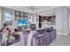 Elegant living room with comfortable velvet seating and a view into the kitchen at 130 Riviera Dunes Way # 203, Palmetto, FL 34221
