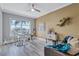 Bright home office with a modern desk, comfortable seating, and scenic views from a large window at 130 Riviera Dunes Way # 203, Palmetto, FL 34221