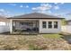 The backyard offers a screened-in patio with comfortable seating and space for relaxation and entertaining at 1423 W Wood St, Tampa, FL 33604