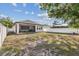 Backyard featuring a covered patio, a well-maintained lawn, and privacy fencing, ideal for outdoor enjoyment at 1423 W Wood St, Tampa, FL 33604