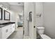 Modern bathroom with a toilet and dual sink vanity, a walk-in shower and tiled floors at 1423 W Wood St, Tampa, FL 33604