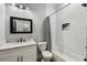 Modern bathroom with white subway tile shower, mosaic floor, marble countertop, and updated fixtures at 1423 W Wood St, Tampa, FL 33604