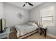 Cozy bedroom with neutral tones, decorative wall art, a ceiling fan, and natural light from the window at 1423 W Wood St, Tampa, FL 33604