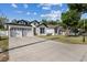 A charming two-story home with manicured lawn, two car garage, and neutral color palette at 1423 W Wood St, Tampa, FL 33604