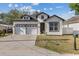 Charming two-story home with a manicured lawn, two car garage, and neutral color palette at 1423 W Wood St, Tampa, FL 33604