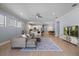 Bright open-plan living area with a sectional sofa, modern flooring, and an adjoining kitchen and dining area at 1423 W Wood St, Tampa, FL 33604