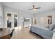 Bright main bedroom with a ceiling fan, desk, dresser, light-colored flooring and access to a private balcony at 1423 W Wood St, Tampa, FL 33604