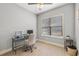 Bright home office with a large window, modern desk setup, and neutral decor for a professional workspace at 1423 W Wood St, Tampa, FL 33604