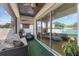Covered outdoor patio featuring a comfortable sofa and lush green carpeting, perfect for relaxation and entertaining at 1423 W Wood St, Tampa, FL 33604