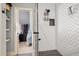 Clean shower with white tiling, black fixtures and a glass door and a walk-in closet with organized storage at 1423 W Wood St, Tampa, FL 33604