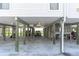 View of covered parking area with two cars and a golf cart at 200 120Th W Ave # 3A, Treasure Island, FL 33706