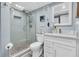 The bathroom features a glass enclosed shower, granite vanity, and modern fixtures at 200 120Th W Ave # 3A, Treasure Island, FL 33706