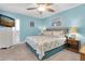 The bedroom has coastal themed decor, a king-size bed, ceiling fan and a shuttered window at 200 120Th W Ave # 3A, Treasure Island, FL 33706