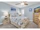 This cozy bedroom is decorated with ocean-themed artwork, a queen bed and light blue paint at 200 120Th W Ave # 3A, Treasure Island, FL 33706