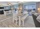 The dining area features a table with seating for six, large mirror and floor to ceiling windows with beach views at 200 120Th W Ave # 3A, Treasure Island, FL 33706