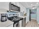 Cozy kitchen with stainless steel appliances and light-blue tile backsplash at 200 120Th W Ave # 3A, Treasure Island, FL 33706