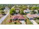Areal view of home with screened in pool, landscaping, and two-car garage at 2017 Godfrey Ave, Spring Hill, FL 34609