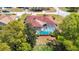 Aerial view of a home showcasing a screened-in pool, landscaped yard, and residential surroundings at 2017 Godfrey Ave, Spring Hill, FL 34609
