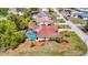 Aerial view of a home with a screened-in pool and landscaped backyard in a residential neighborhood at 2017 Godfrey Ave, Spring Hill, FL 34609