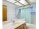 Bathroom featuring large mirror, neutral vanity, and shower with curtain at 2017 Godfrey Ave, Spring Hill, FL 34609