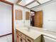 Bathroom featuring large mirror, neutral vanity, and wood medicine cabinets at 2017 Godfrey Ave, Spring Hill, FL 34609