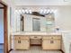 Bathroom displaying a double sink vanity, updated lighting and a large mirror at 2017 Godfrey Ave, Spring Hill, FL 34609