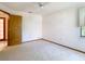 This is a standard bedroom with neutral walls, carpet, and ceiling fan at 2017 Godfrey Ave, Spring Hill, FL 34609