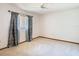 Bedroom with neutral carpet, fan, and window with curtains at 2017 Godfrey Ave, Spring Hill, FL 34609