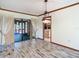 Bright dining room with hardwood floors, glass sliding door, and archway to the kitchen at 2017 Godfrey Ave, Spring Hill, FL 34609
