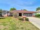 Home exterior showcasing front lawn and attached two-car garage at 2017 Godfrey Ave, Spring Hill, FL 34609
