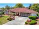 Charming home features a well-maintained lawn, lush landscaping, and a spacious two-car garage at 2017 Godfrey Ave, Spring Hill, FL 34609