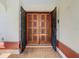 Inviting double front doors, with unique square decorative paneling and black security doors at 2017 Godfrey Ave, Spring Hill, FL 34609