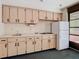 Small kitchen with ample cabinets, tile backsplash, and access to the screened-in pool area at 2017 Godfrey Ave, Spring Hill, FL 34609