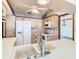 Bright kitchen featuring white appliances, overhead cabinets, and a view of the dining area at 2017 Godfrey Ave, Spring Hill, FL 34609