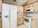 Efficient kitchen with white appliances, light cabinetry, and ample storage space at 2017 Godfrey Ave, Spring Hill, FL 34609