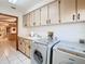 Spacious laundry room with sink and front loading washer and dryer at 2017 Godfrey Ave, Spring Hill, FL 34609