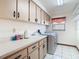 This laundry room features lots of upper cabinet storage at 2017 Godfrey Ave, Spring Hill, FL 34609