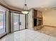 Open living area with stone fireplace, tiled floors, and access to outdoor pool area at 2017 Godfrey Ave, Spring Hill, FL 34609