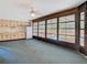 Bright living room with kitchen, ceiling fan, and access to the pool area via large sliding glass doors at 2017 Godfrey Ave, Spring Hill, FL 34609
