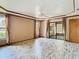 A bright main bedroom offers trey ceilings, tile floors, and a view of the backyard at 2017 Godfrey Ave, Spring Hill, FL 34609