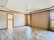 A spacious main bedroom offers trey ceilings, tile floors, and access to an en-suite bathroom at 2017 Godfrey Ave, Spring Hill, FL 34609