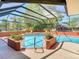 Relaxing screened-in pool area with mature landscaping, offering a serene and private outdoor retreat at 2017 Godfrey Ave, Spring Hill, FL 34609