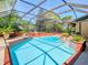 Inviting screened-in pool with brick trim, providing a private oasis for relaxation and recreation at 2017 Godfrey Ave, Spring Hill, FL 34609